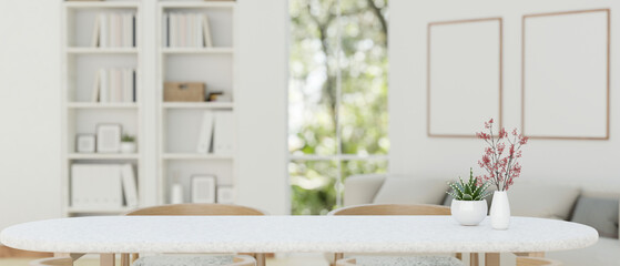 Copy space on a white dining table with a blurred modern Scandinavian white living room