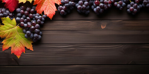 Black juicy grapes on dark wooden background.
