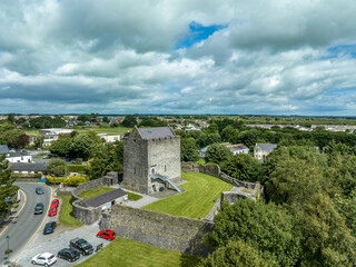 Fototapeta na wymiar Aerial view of Athenry castle tower house dramatic three-storey hall-keep survives from the mid-thirteenth century, large, rectangular building with gabled roof and medieval walled town and priory in 
