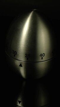Time lapse of a kitchen clock timer countdown to zero.