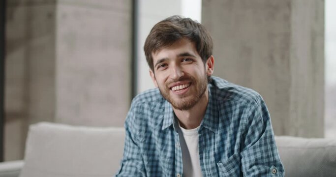 Young white man with kind smile looks into camera radiating friendly vibe captures essence of true friend creating connection with viewer. Witness sincere camaraderie of relatable and engaging content