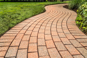 Brick pavers arranged in a curving pattern. - Powered by Adobe