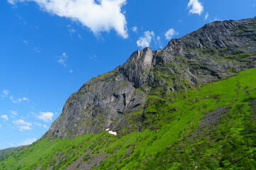 Beautiful classic Norwegian summer landscape in the month of July. mighty mountains meadows, sea. Beautiful classic summer view over the fjord.