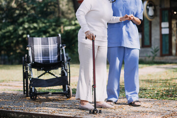 Asian young woman nurse at nursing home take care disabled senior man. Caregiver doctor serve...
