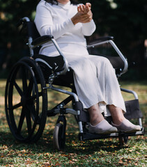 Obraz premium Asian young woman nurse at nursing home take care disabled senior man. Caregiver doctor serve physical therapy for older elderly patient to exercise and practice walking on walker or cane at backyard.