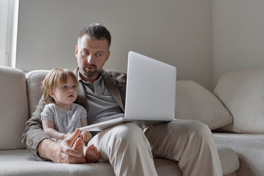 Man showing laptop to charming little girl