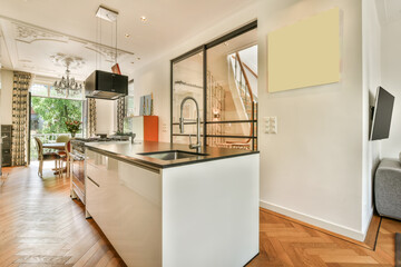 a kitchen and living room in an apartment with wood floors, white walls, hardwood flooring and...