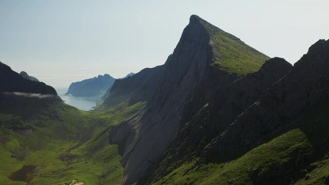 Cinematic rising drone shot of cliffs at Horseid Beach.  Northern side of Moskenes&oslash;y, in the western part of Lofoten