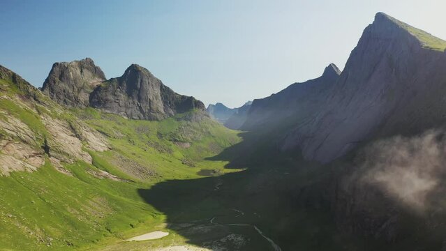 Cinematic drone shot of Horseid Beach with turquoise blue water, clouds moving over cliffs. Northern side of Moskenes&oslash;y, in the western part of Lofoten