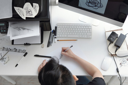 Female artist working on tattoo sketch