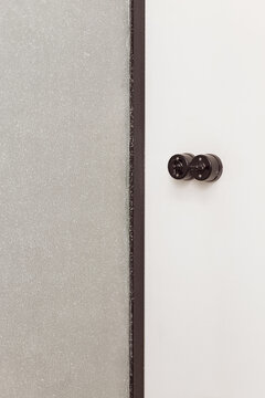 Black knobs on white wall inside