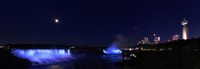 Aerial view of Niagara Falls illuminated on dusk and Niagara River, Canada and USA natural border