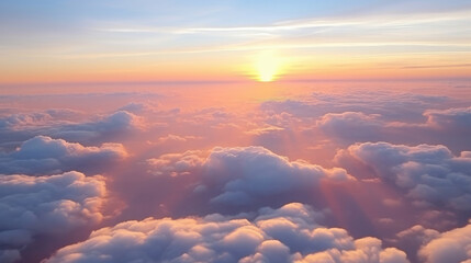 Beautiful sunset sky above clouds with dramatic light. Cabin view from airplane