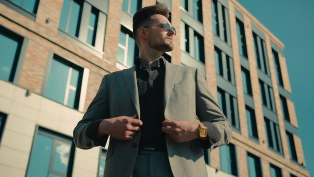 Confident elegant man in sunglasses outdoors near office building successful wealthy rich businessman entrepreneur corporate leader business partner investor financial director ceo posing on street