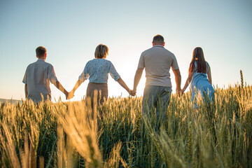 family in the field at sunset, child, mother, father, sunset. happy family, outdoor recreation,...