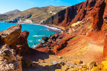 Red beach in Santorini island, Greece. Red volcanic cliffs and the blue sea