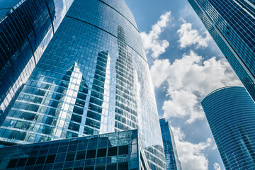Modern glass skyscrapers against the blue sky with clouds. Moscow city, Russia.