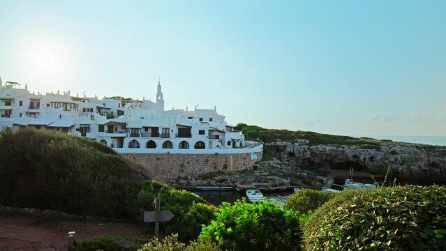 Beautiful panoramic view of Binibeca Coastal Village with whitewashed houses. An early morning sunrise over Binibeca Vell a Calm Cove Resort in Menorca, Balearic Islands, Spain.