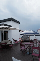 Exterior decoration and design of public outdoor terrace and garden patio decorated with red metal table and chair