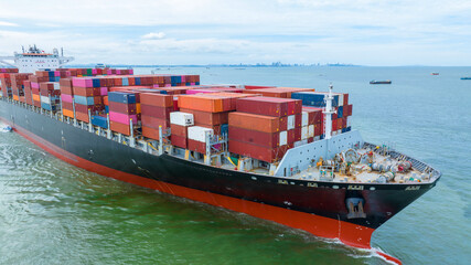Aerial side view of cargo container ship carrying container from custom container depot go to ocean...