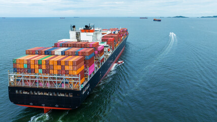 Aerial Stern view of cargo container ship carrying container from custom container depot go to...
