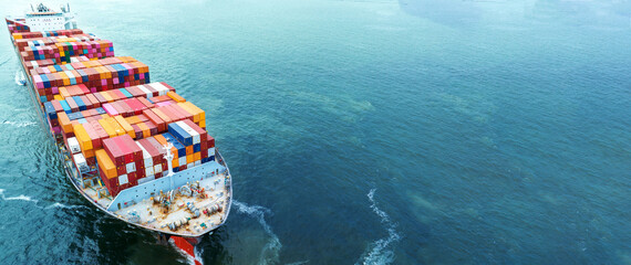 Aerial side view of cargo container ship carrying container from custom container depot go to ocean...