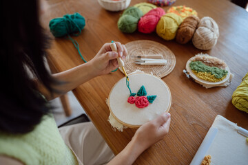 Punch needle. Asian Woman making handmade Hobby knitting in studio workshop. designer workplace Handmade craft project DIY embroidery concept.