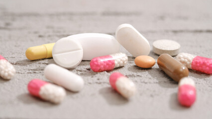 A variety of pharmaceutical pills, tablets and capsules on a vintage background, a copy space for business.