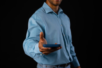 Biracial businessman using smartphone on black background