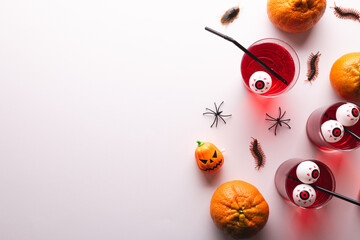 Halloween decorations and food with copy space on white background