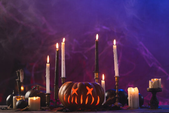 Fototapeta Pumpkins and candles with copy space on purple background