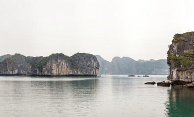 Scenic view on rock islands with fishing boats in Ha Long Bay. Cat Ba, Vietnam.