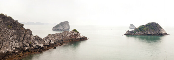 Scenic view on rock islands with fishing boats in Ha Long Bay. Cat Ba, Vietnam.