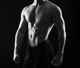 Fototapeta na wymiar Strong, fit and sporty bodybuilder man over black background