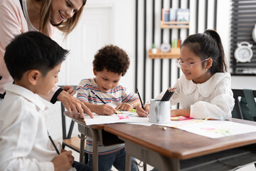 Student Asia kid girl studying with friend and teacher in classroom	