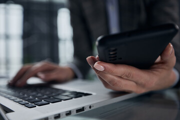 close up hand using phone screen on workspace table