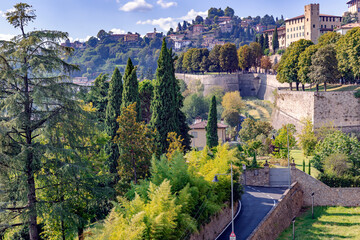  View of the old town Bergamo with an old castle in northern Italy on the background of the Alpine mountains. Bergamo is a city in the alpine Lombardy region. - obrazy, fototapety, plakaty
