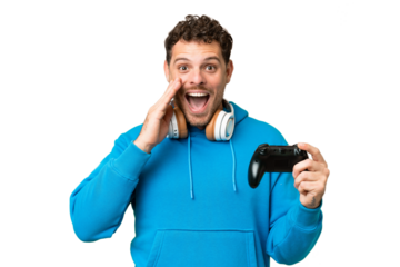 Brazilian man playing with a video game controller over isolated chroma key background with surprise and shocked facial expression