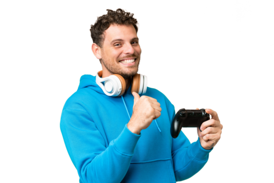 Brazilian man playing with a video game controller over isolated chroma key background proud and self-satisfied