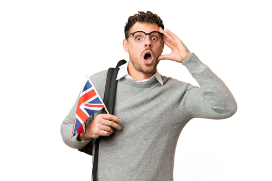 Brazilian man holding an United Kingdom flag over isolated chroma key background with surprise expression