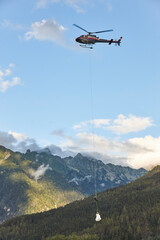 Fototapeta na wymiar Helicopter rescue training simulation in a mountain range wood. Firefighter