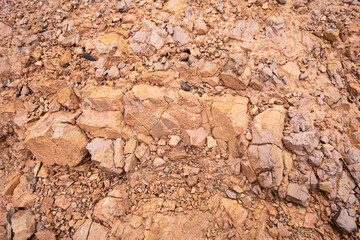Weathered rock background. Brown highly weatered stone.