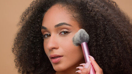 Close up portrait at beige studio background beautiful African American woman attractive ethnic...