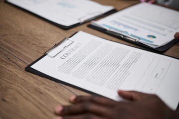 Contract with hand on table signs business transaction