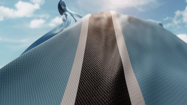 Wavy flag of Botswana blowing in the wind in slow motion. Waving colorful Botswanian flag team symbol abstract vertical background. Blue sky with clouds. World Countries flying flags concept