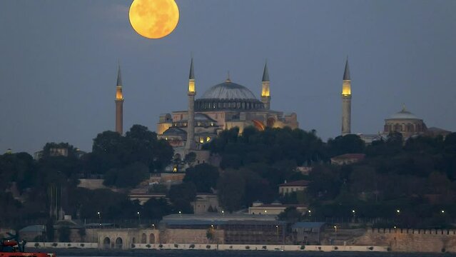 Istanbul Turkey  08 30 2023 timelapse of super full moonset on top of hagia sophia at morning