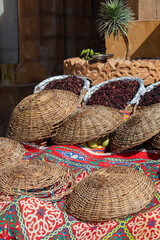 Dried hibiscus flowers in baskets on the stand on street bazaar in Egypt. Hibiscus brewed tea is very popular in Arab countries