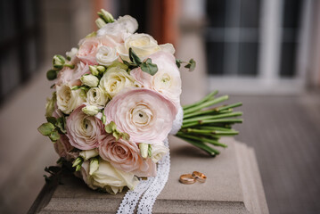 Bouquet white and pink flowers roses and greenery with wedding rings bride and groom. Two beautiful...