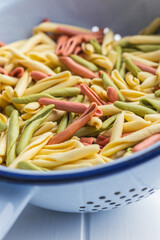Fusilli pugliesi. Italian twisted pasta in colander.