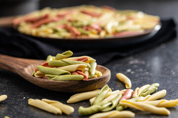 Fusilli pugliesi. Italian twisted pasta on wooden spoon.